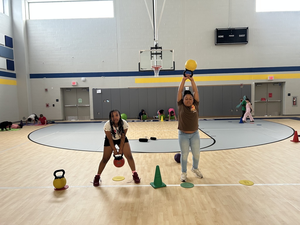 Students in gym class lifting weights.