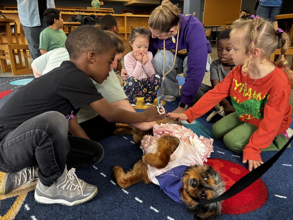 students interacting with therapy dog 