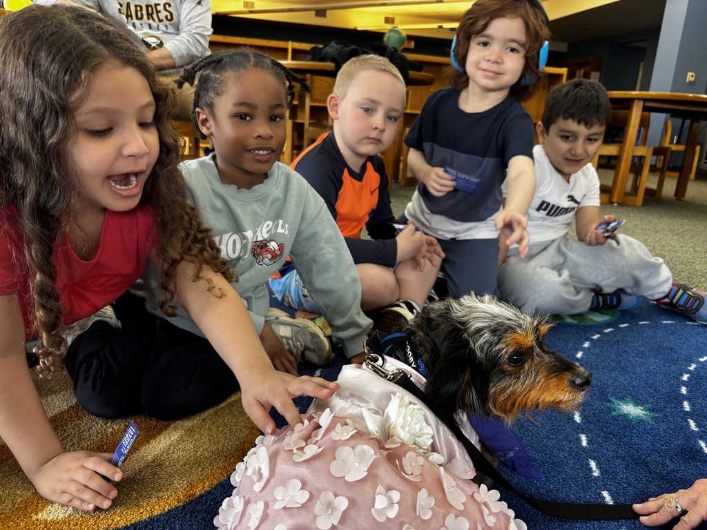 students interacting with therapy dog 
