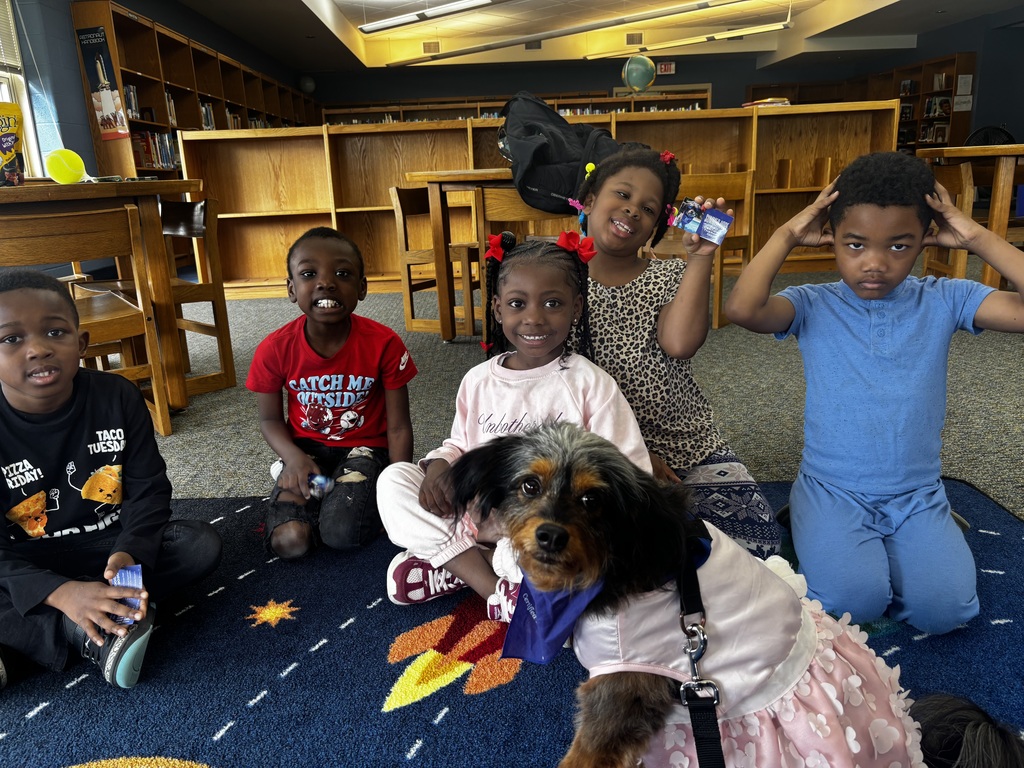 students interacting with therapy dog 