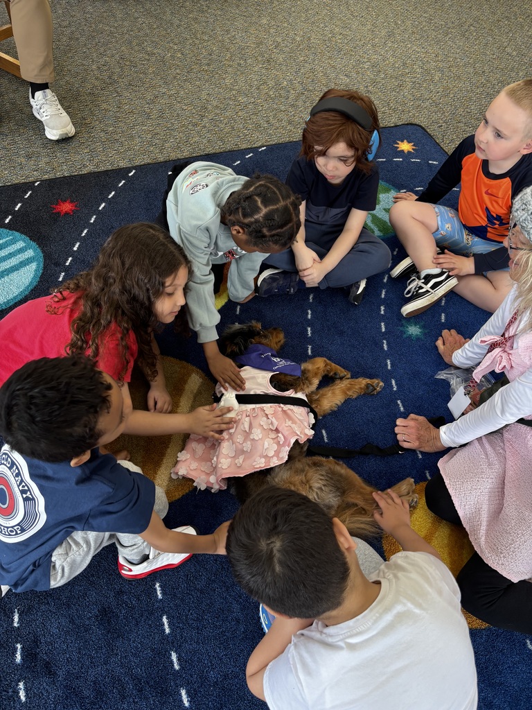 students interacting with therapy dog 