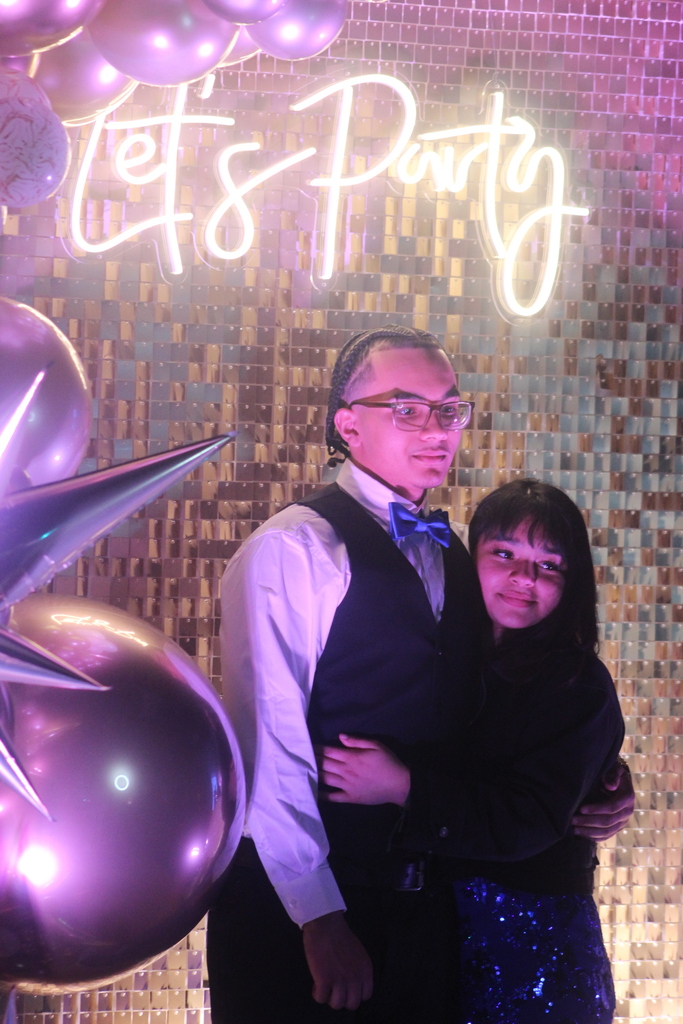 Erie High students taking a photo in front of a backdrop at prom 2026. 