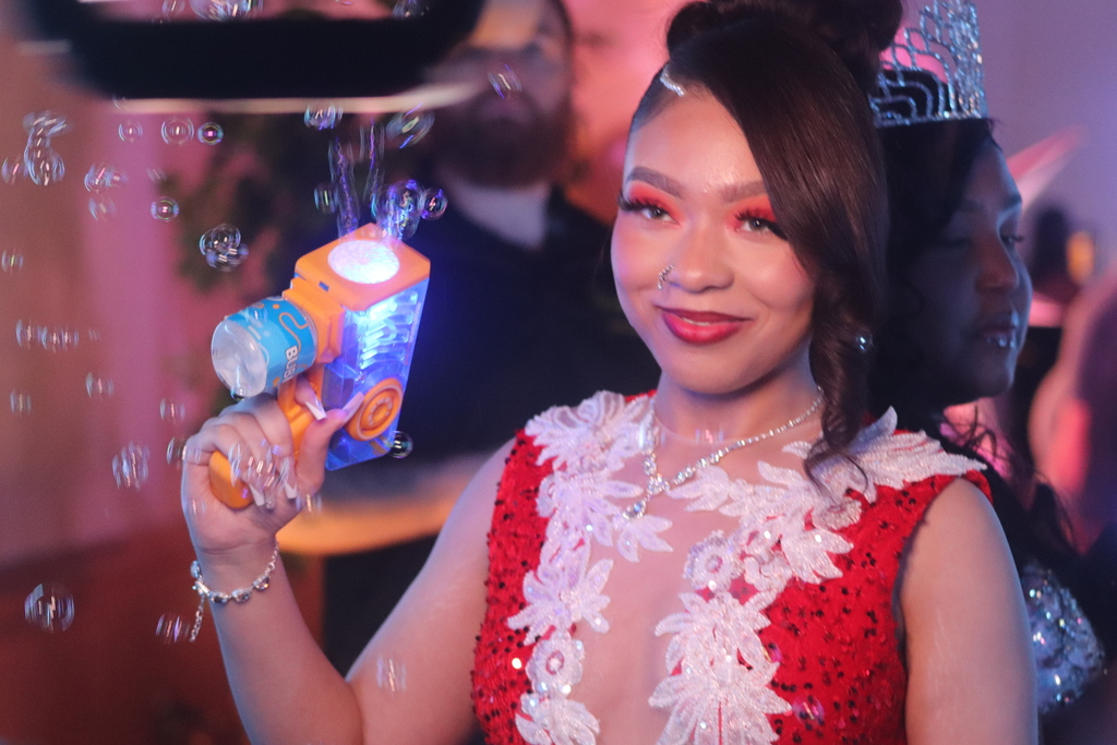 Erie High student posing for photo with bubble machine. 