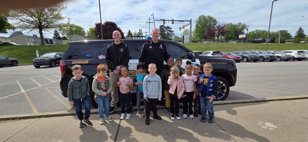 student standing with Erie police