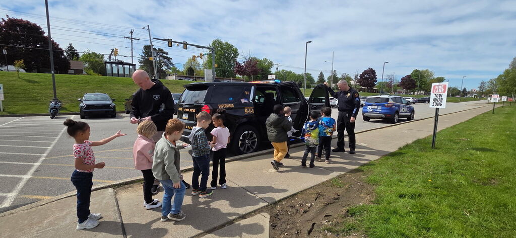 students exploring k9 unit police car