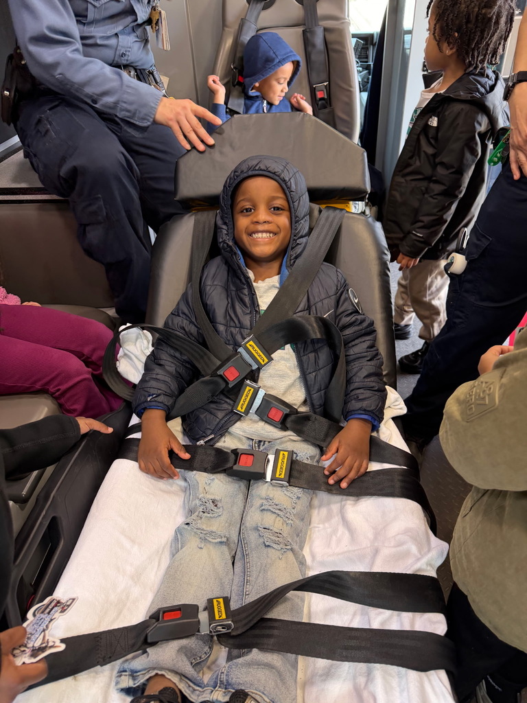 student strapped into a hospital bed from the ambulance