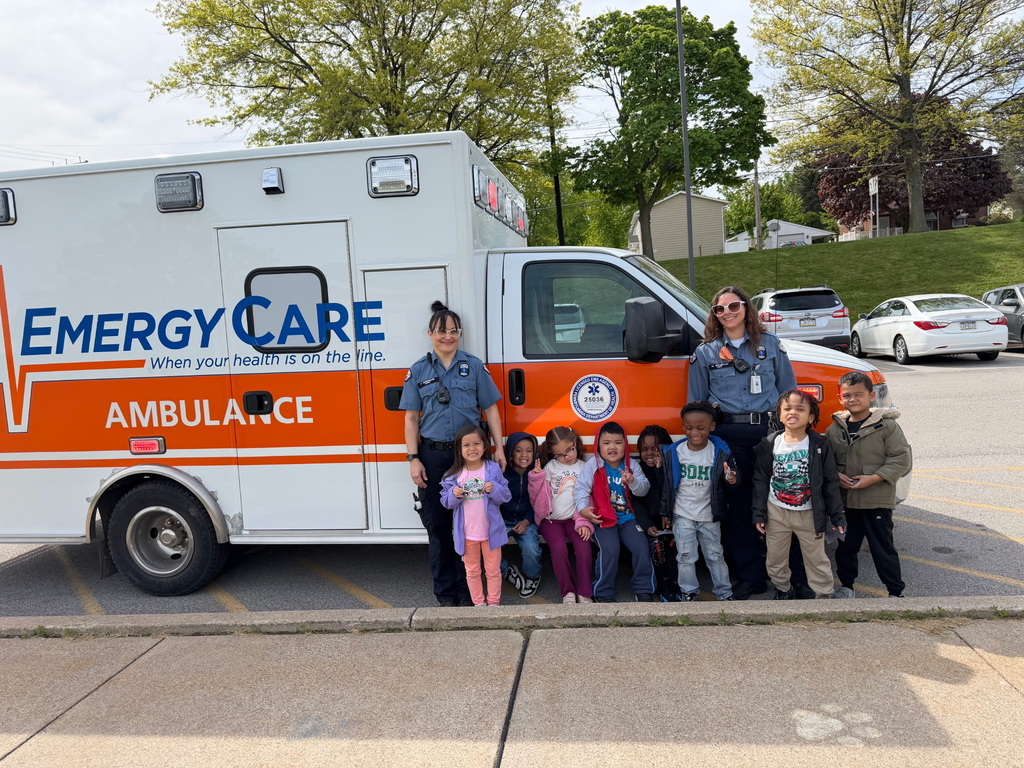 student standing with ambulance
