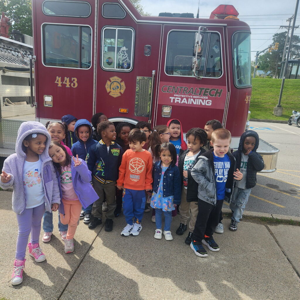 student standing in front of fire truck