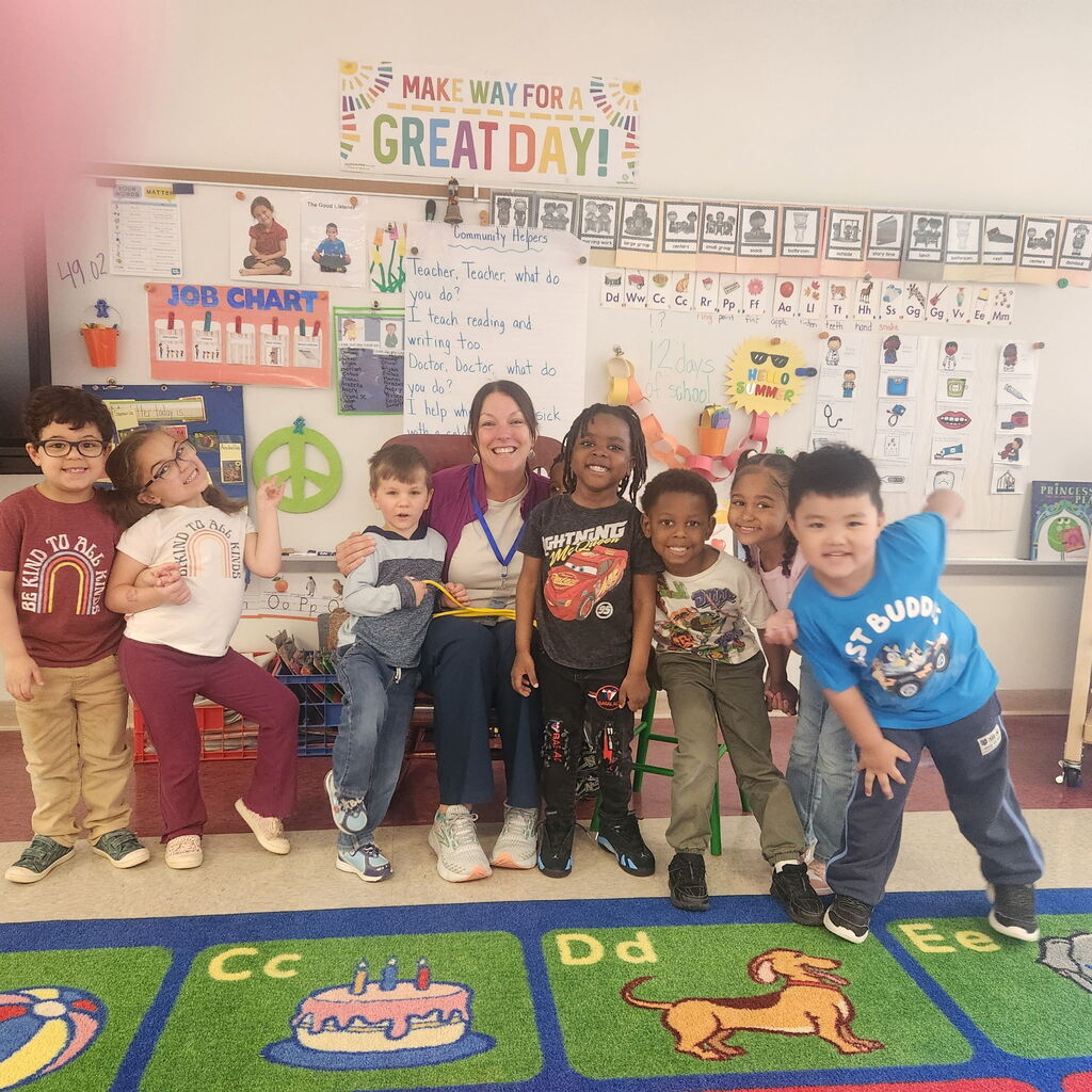 students sitting with community health partner