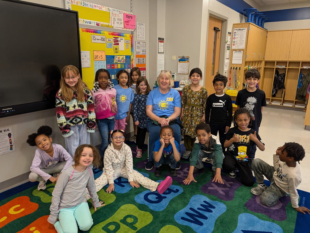 Edison students posing with their Hooked on Books for Kids volunteer.