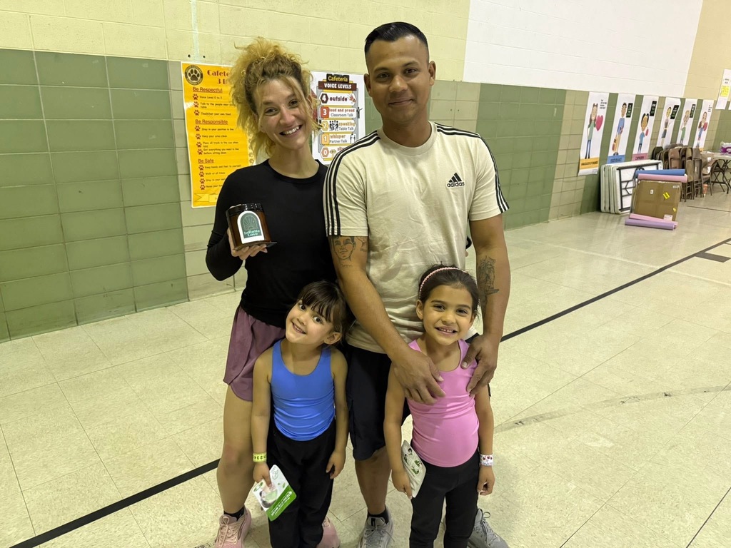 Family of 4 holding a candle from giveaway