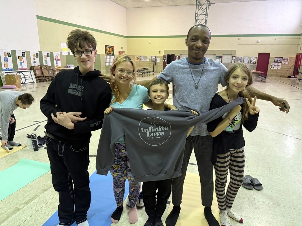Family of 5 holding a sweatshirt from giveaway