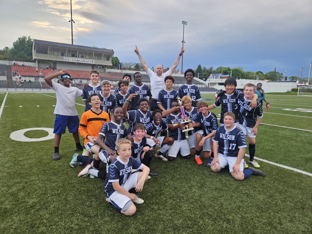 Boys soccer team with championship trophy.