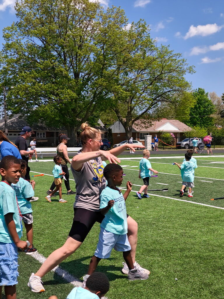teacher with student participating in special Olympic