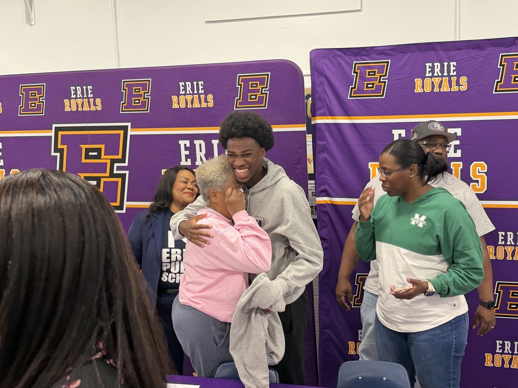A student hugging his grandma that is crying.