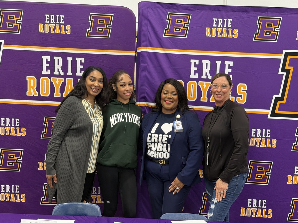 A family, a coach, and Superintendent Dr. Natalyn Gibbs posing for a photo.
