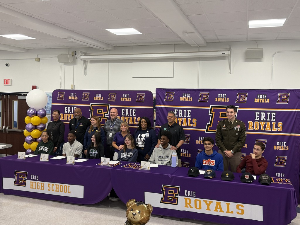 Teachers, students, coaches, and man in uniform posing for a photo.