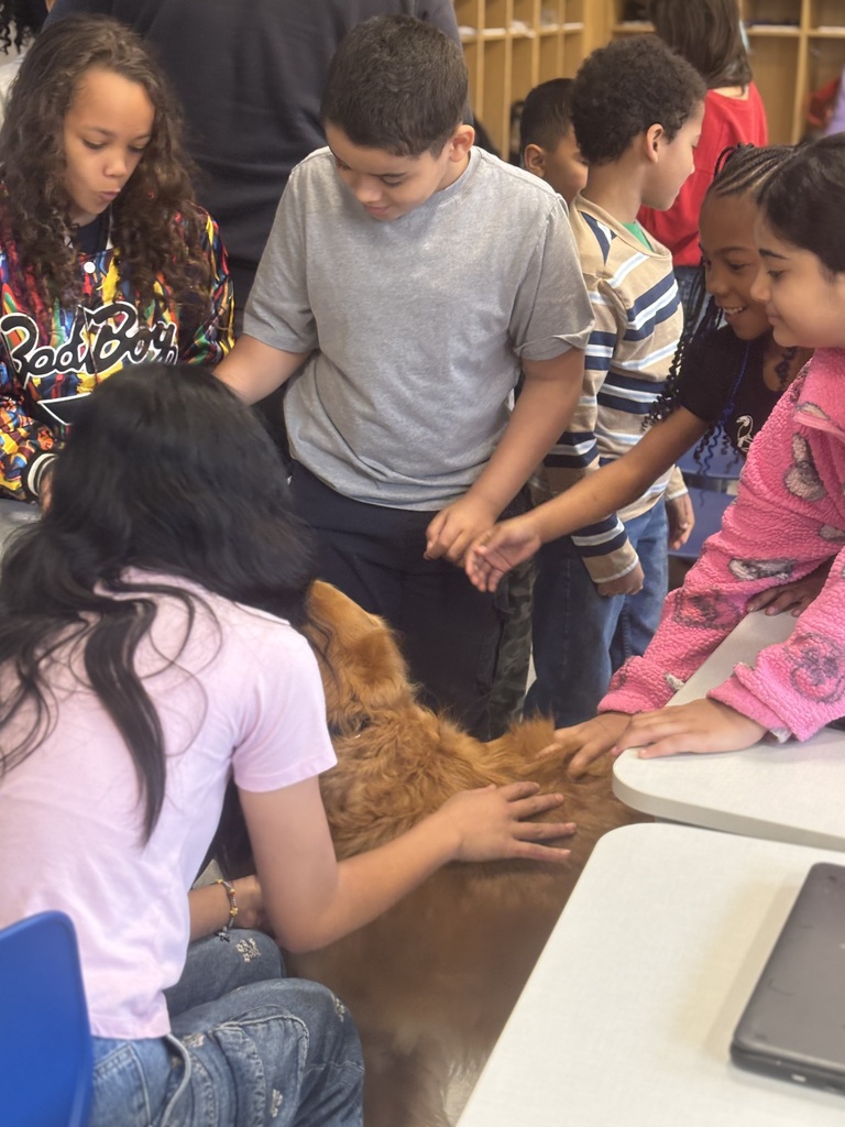 Edison students petting a dog as part of Career Speaker Day.