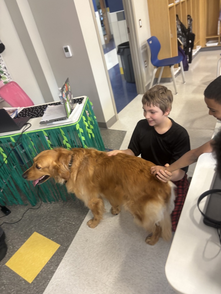 Edison students petting a dog as part of Career Speaker Day.