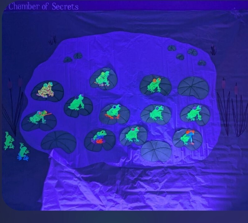 black light art display glowing frogs in lily pond