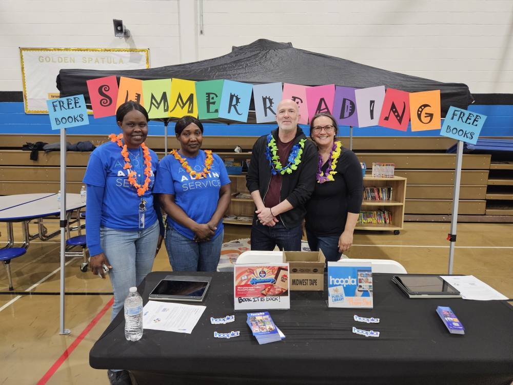 erie insurance and community volunteers at Summer of Reading station at summer resource fair