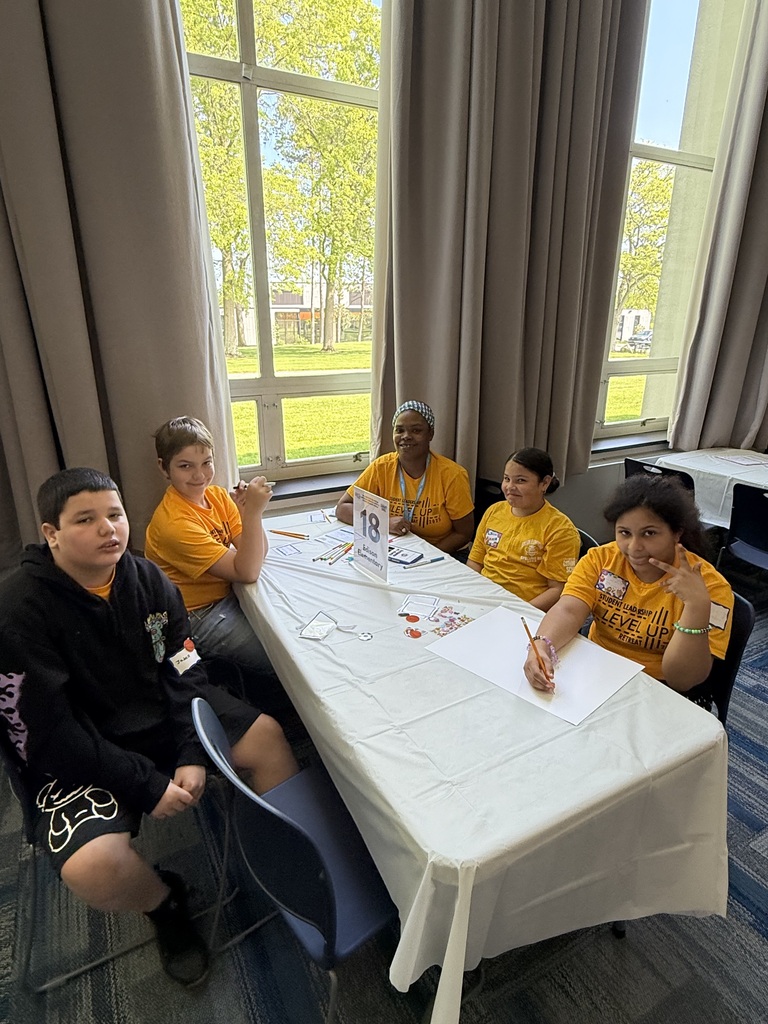 Edison student leaders sitting at their table at the student leadership retreat.
