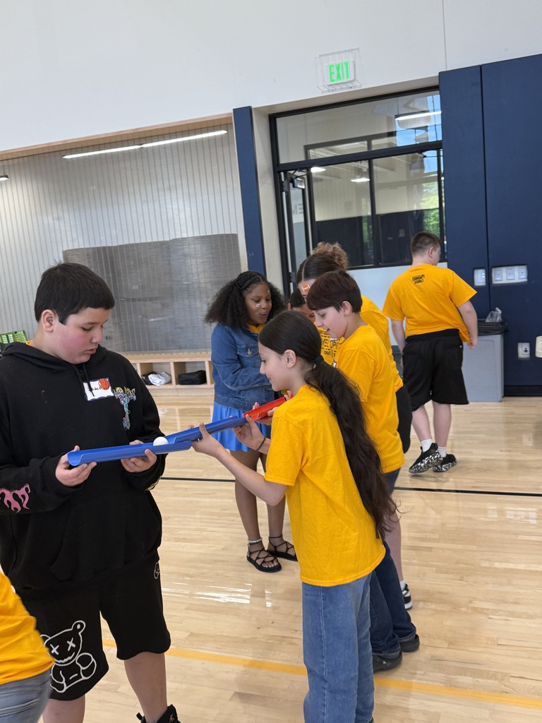 Edison students playing a game where they work as a team to make a ball to flow through open tubes as far as they can.