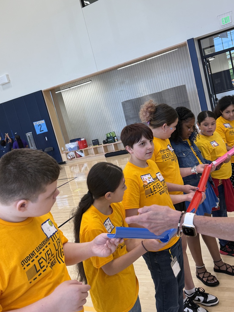 Edison students playing a game where they work as a team to make a ball to flow through open tubes as far as they can.