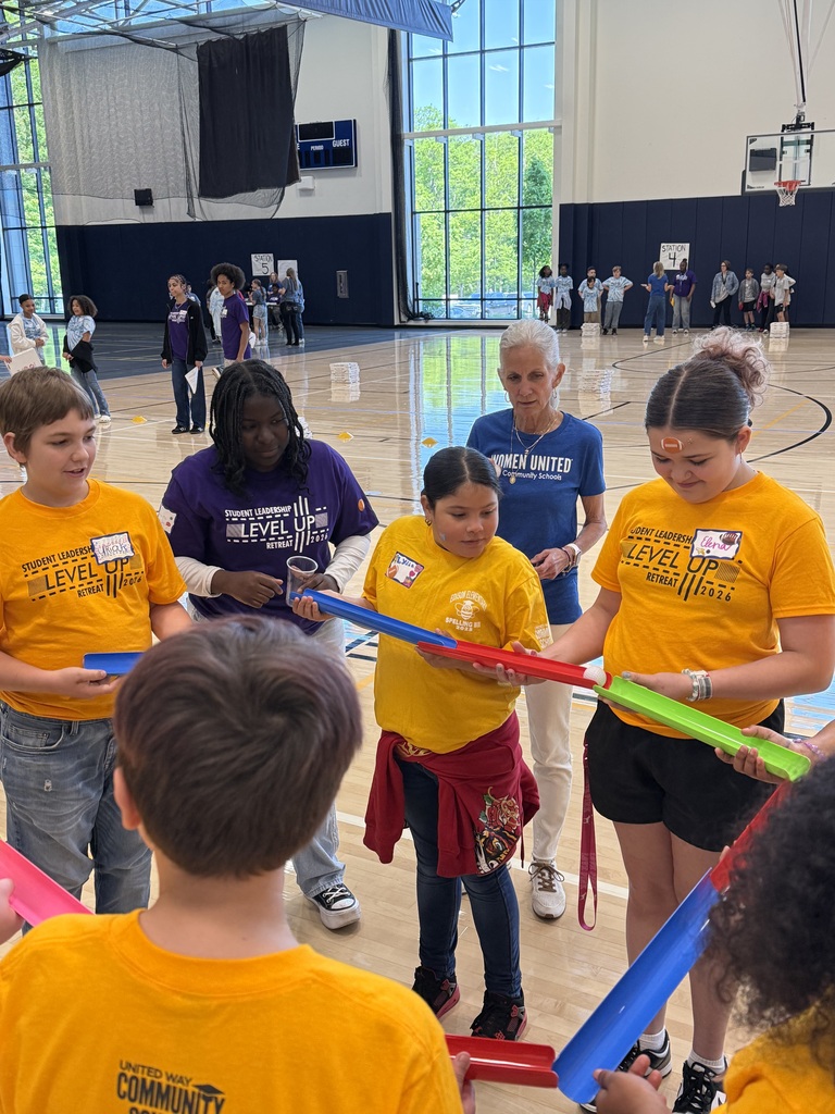 Edison students playing a game where they work as a team to make a ball to flow through open tubes as far as they can.