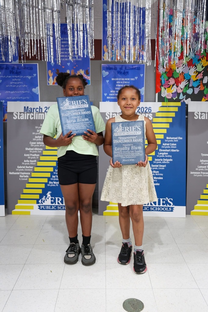 Two students posing while holding their Stairclimber awards.