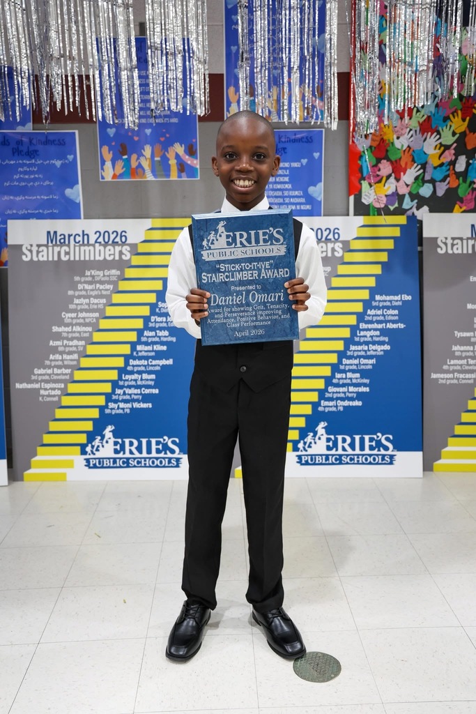 A student posing while holding their Stairclimber award.