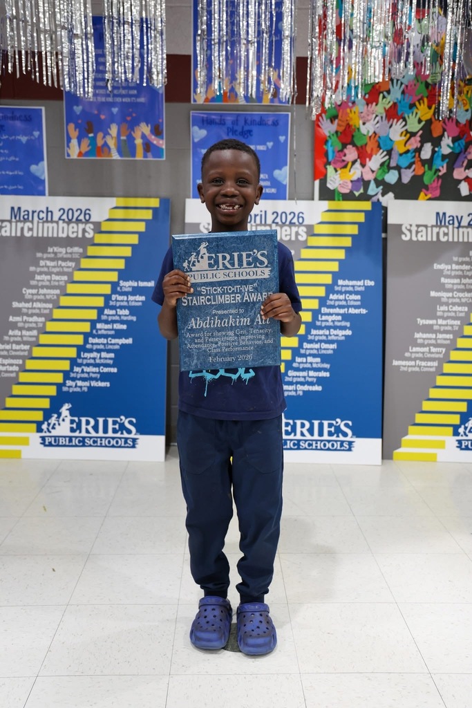 A student posing while holding their Stairclimber award.