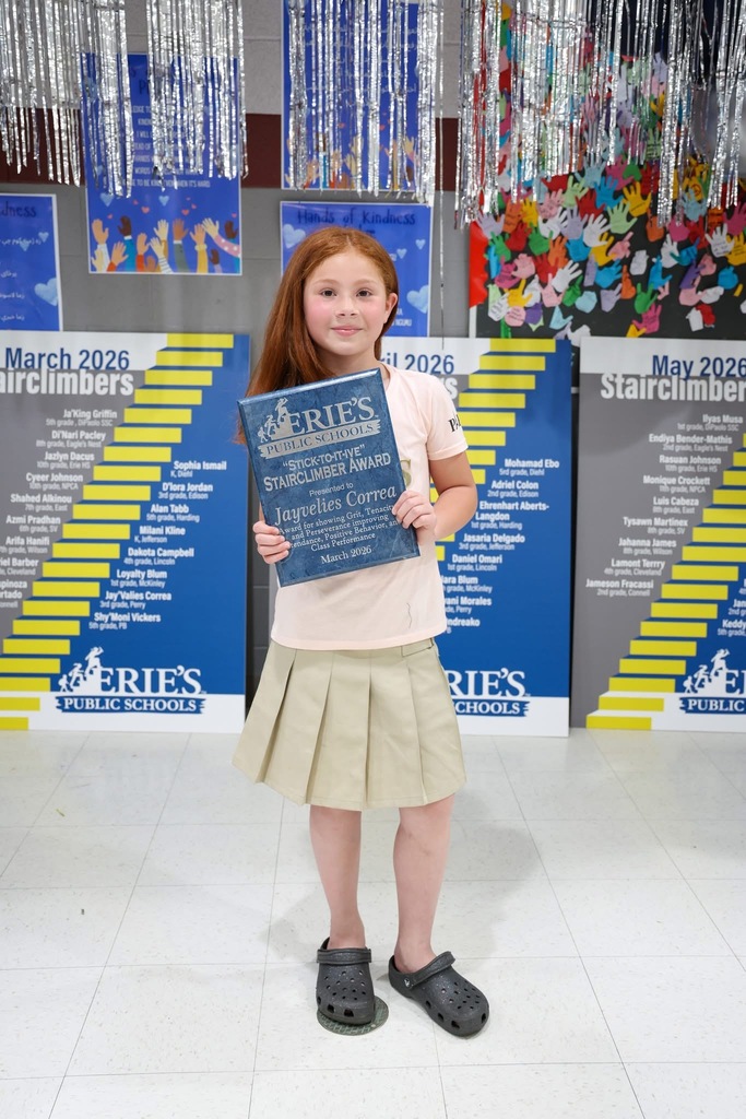 A student posing while holding their Stairclimber award.