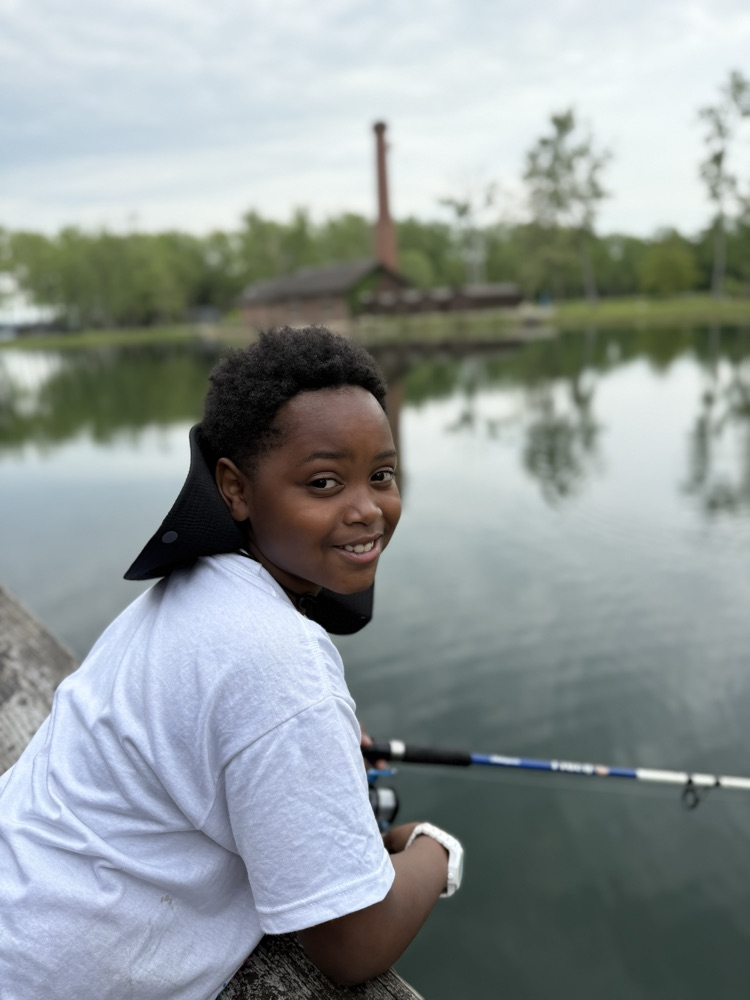 student at family fishing event at the waterworks pond 