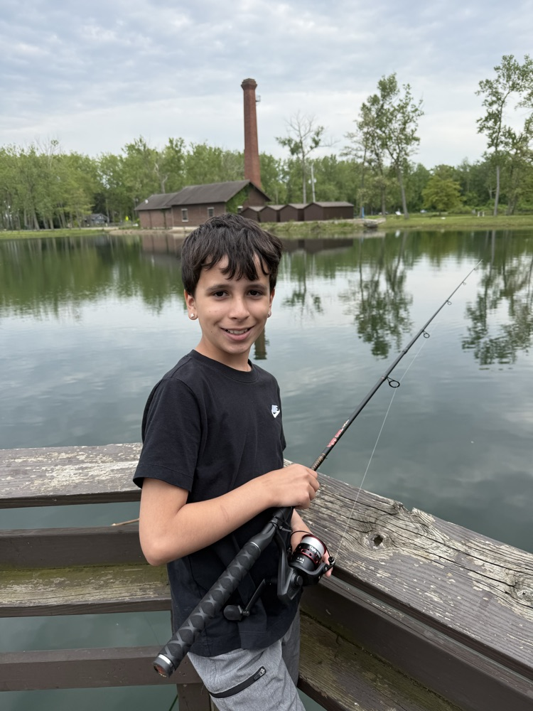 student at family fishing event at the waterworks pond 