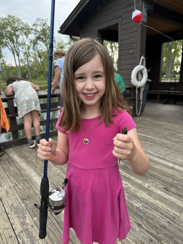 student at family fishing event at the waterworks pond 