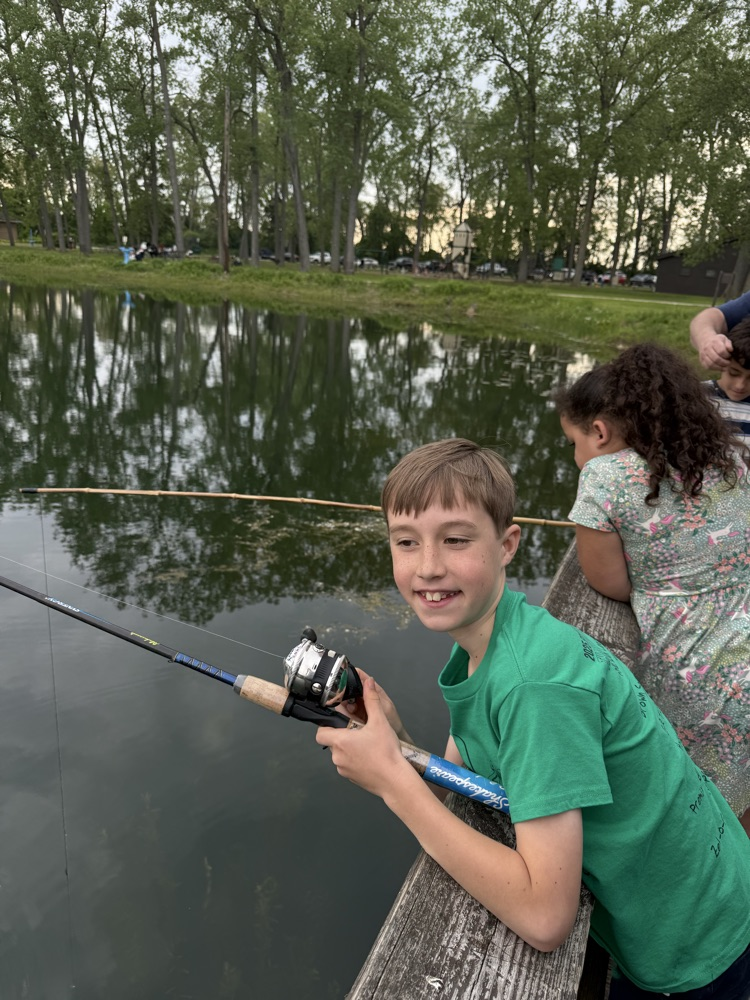 student at family fishing event at the waterworks pond 