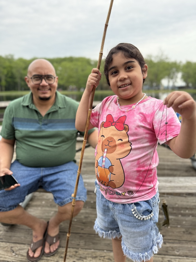 student at family fishing event at the waterworks pond 