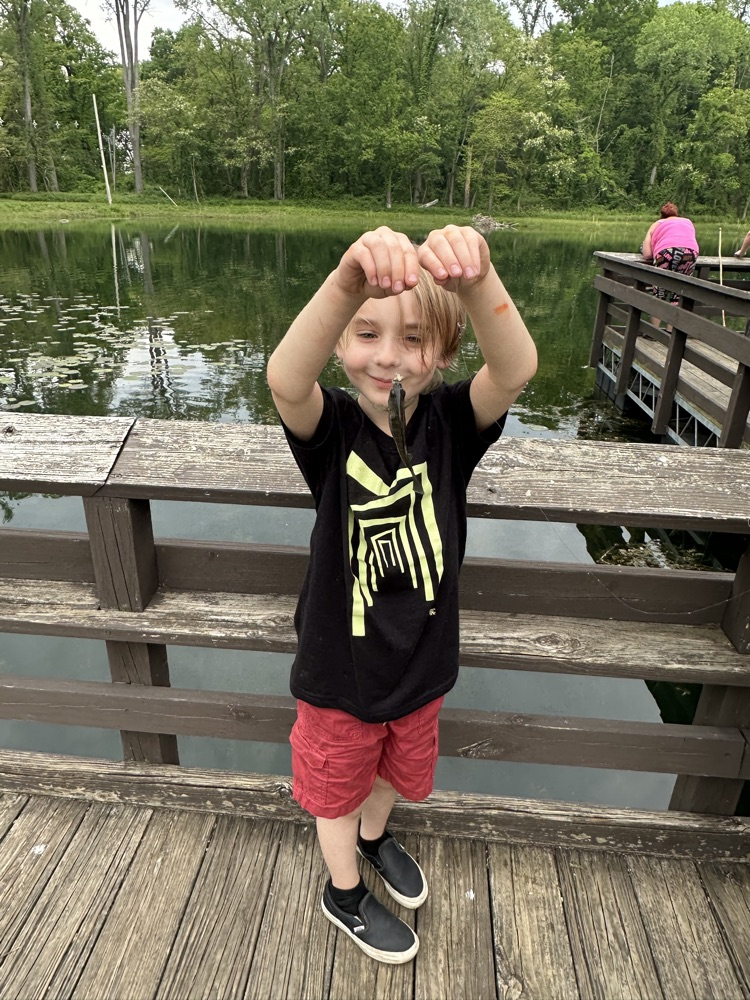 student at family fishing event at the waterworks pond 