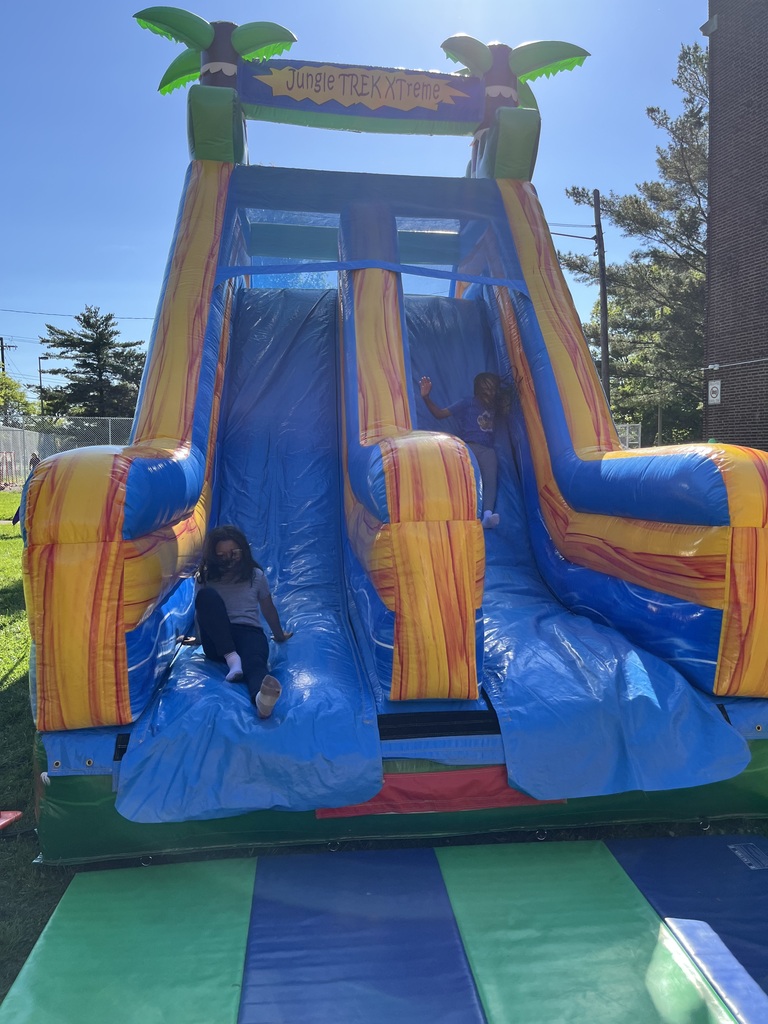 Students going down the inflatable slide.