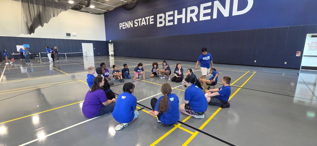 Ambassadors sitting in a circle during the game station portion of the retreat.