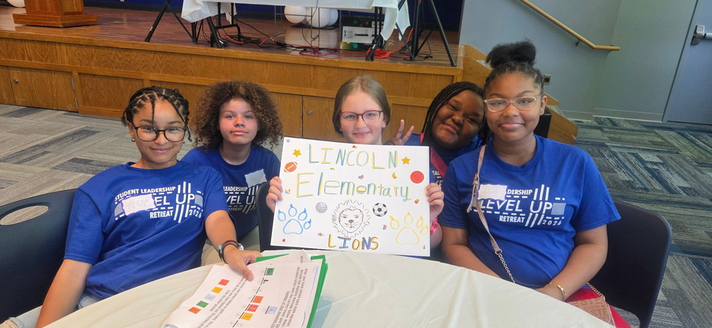 Lincoln Ambassadors with their handmade "Lincoln Elementary" sign.