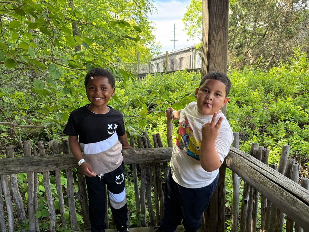 Students posing for a picture at the zoo.