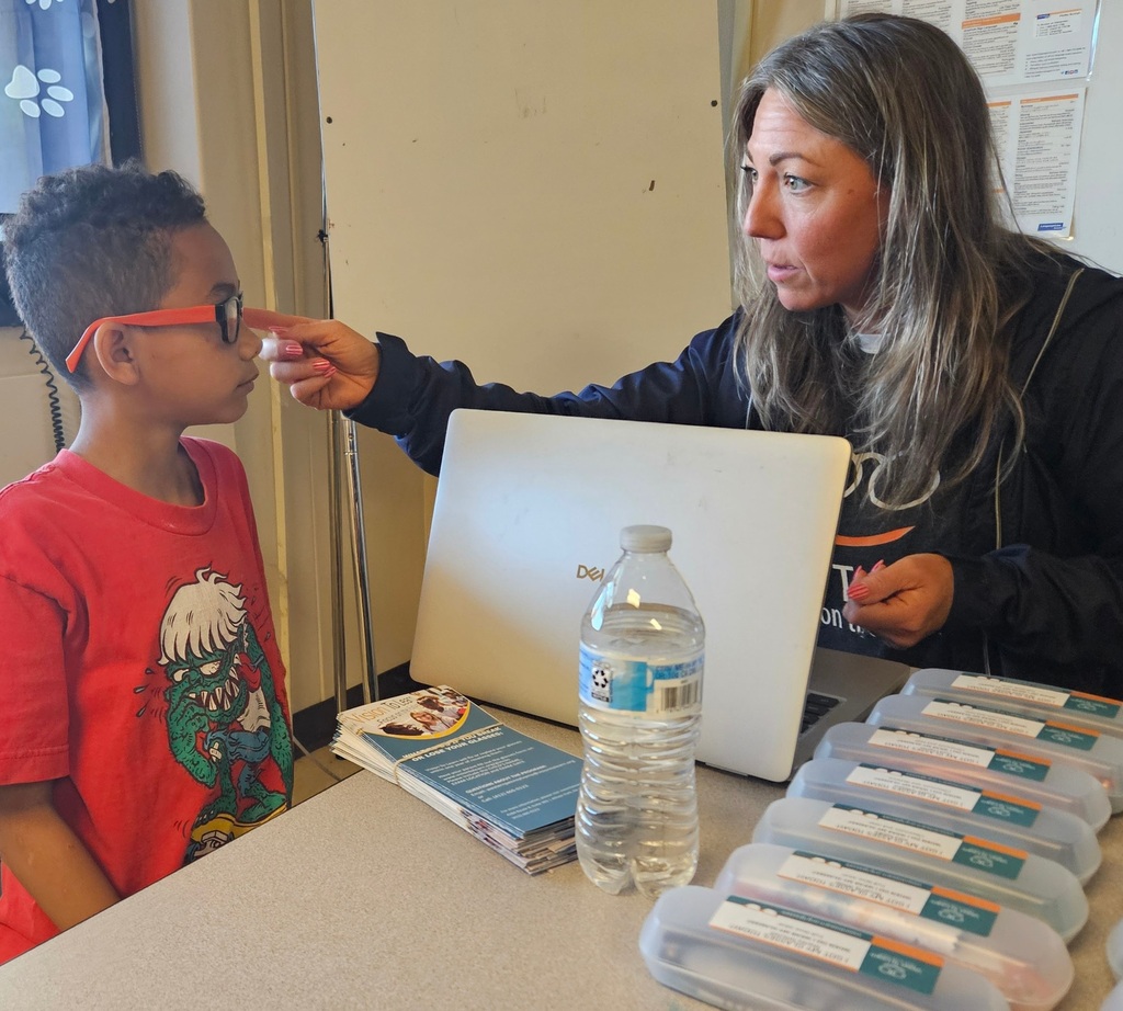 student being fitted for glasses by Vison to Learn staff