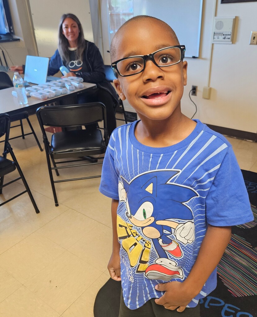 student wearing new glasses