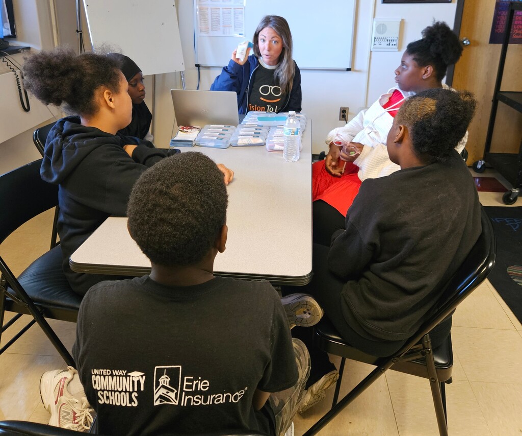 Vision to Learn staff teaching students how to care for their new glasses