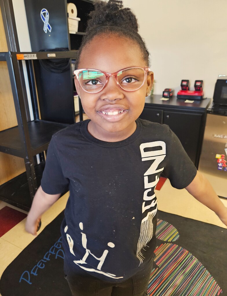 student wearing new glasses