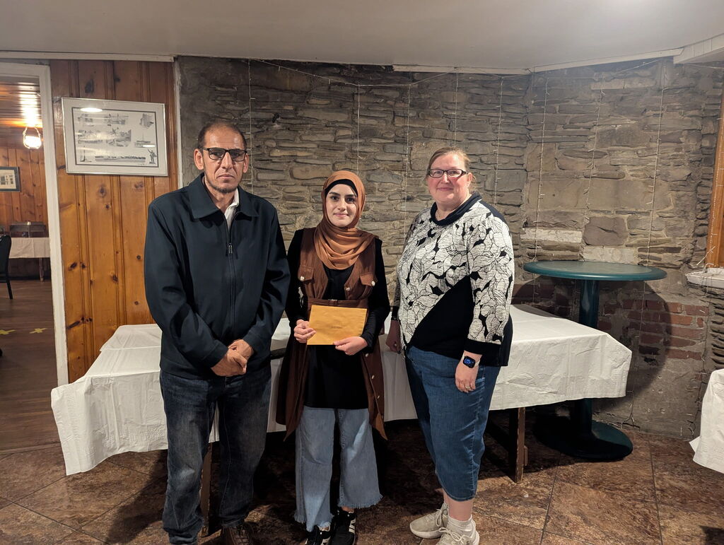 Erie High graduate Sana Sahak poses with the presenters of the Erie County Council PTA Senior Scholarship award.