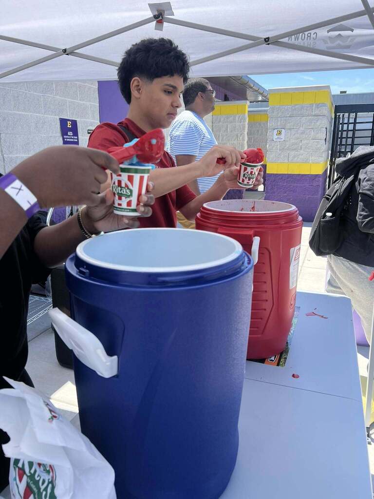 Erie High students distributing Rita's Italian Ice during field day.