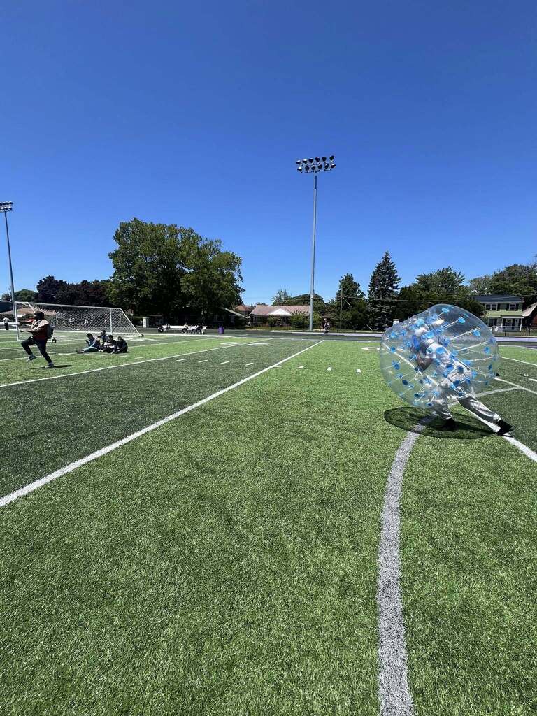 Student running in inflatable bumper ball.